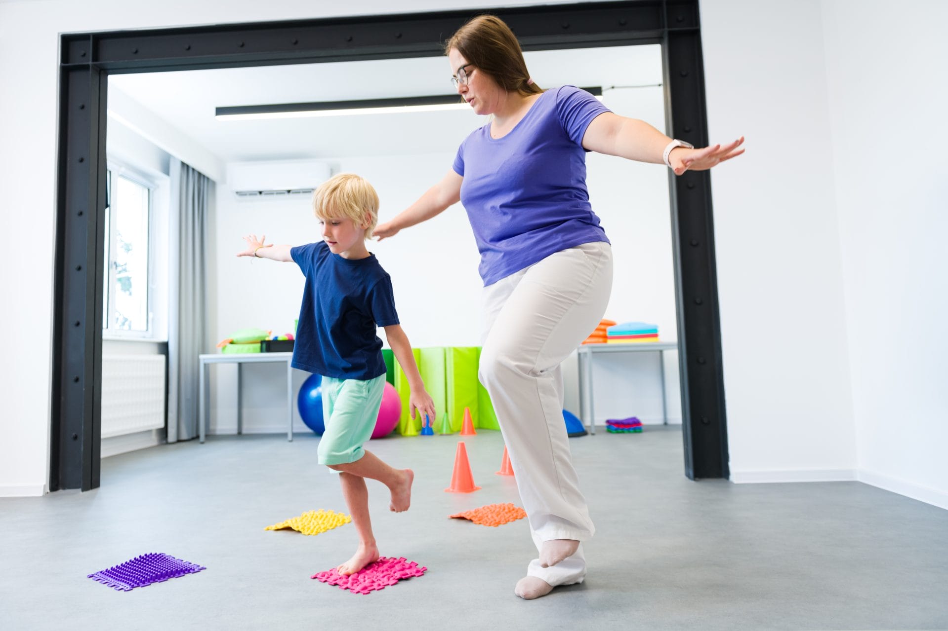 Children running indoors as part of a playful classroom activity.
