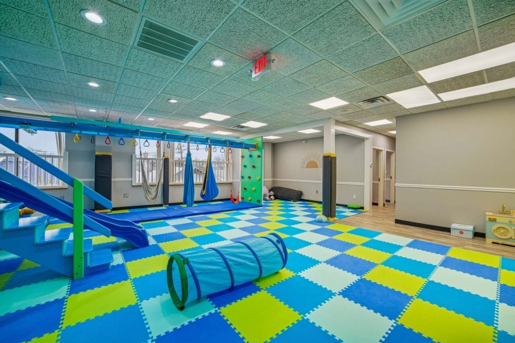 Hallway with wood flooring, built-in bench seating, and wall mural accents.