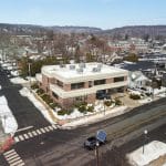 Elevated neighborhood view showing clinic location among residential and commercial buildings in winter.
